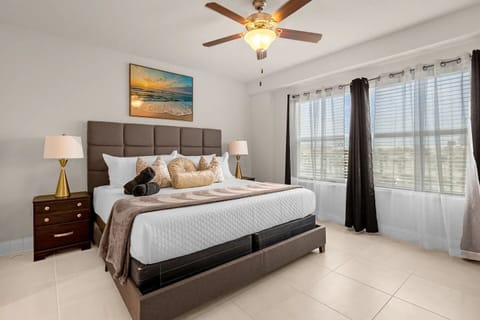 Master bedroom with ceiling fan and private TV. 