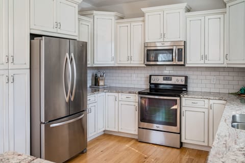 kitchen includes stainless refrigerator, stove, microwave, sink, and dishwasher.