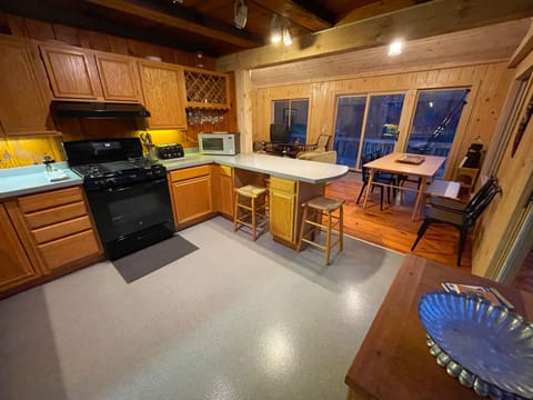 Full kitchen with sliding glass doors that lead to the deck for grilling