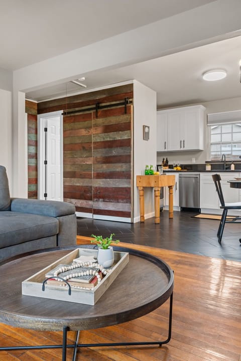 Full size stacked washer and dryer behind barn door
