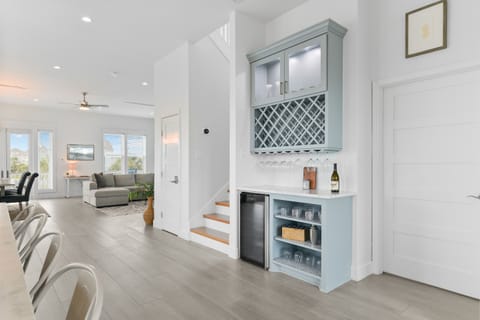 Bar area with wine chiller, drinkware (both glass and plastic), and storage