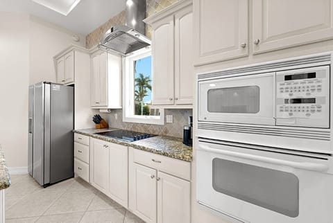Kitchen with a view of the front and a palm tree  