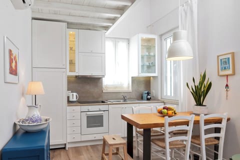 "Prepare delicious meals in our fully equipped kitchen, complete with a dining table for four."