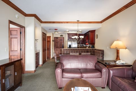 - Spacious living area with leather sofas and kitchen access nearby  
- Open layout flows naturally from entry to dining and fireplace  
- Comfortable retreat for relaxing after adventures on the slopes