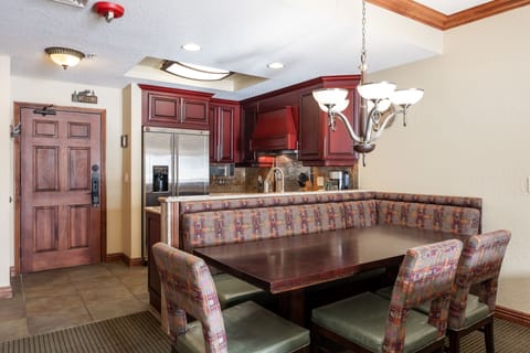 - Dining area with built in banquette and stylish chandelier lighting  
- Seating for the whole group to enjoy meals prepared in full kitchen  
- Conveniently connected to stainless steel appliances and workspace
