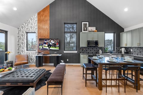 3rd Floor: Bright open living space featuring smart flat-screen TV, designer furnishings, and access to a private balcony with spectacular views of Downtown Nashville.