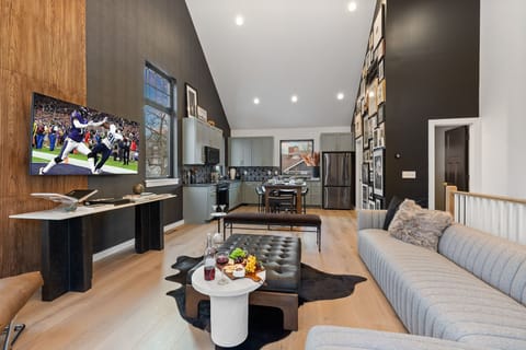 3rd Floor: Bright open living space featuring smart flat-screen TV, designer furnishings, and access to a private balcony with spectacular views of Downtown Nashville.