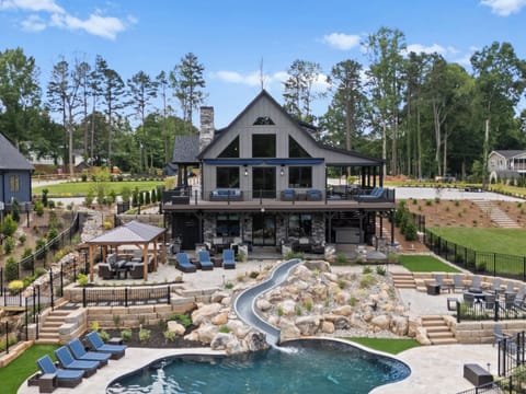 Backyard oasis at Gray Fox pool with slide,  fire-pit and plenty of outdoor seating options. 