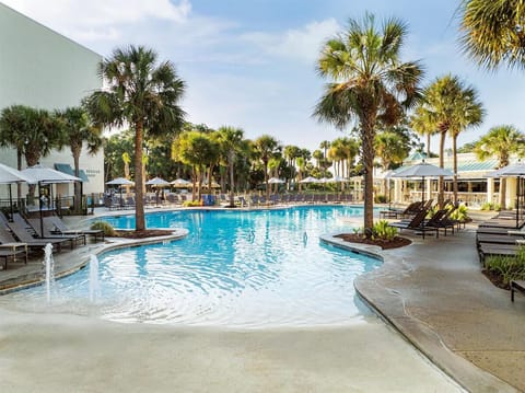 Slip into the sparkling lagoon pool under swaying palms.