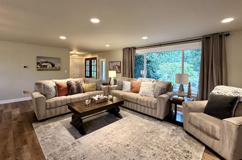 Living room with gorgeous brand new furniture & beautiful front garden view!