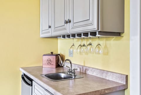 Enjoy coffee in a cozy kitchen nook with wine rack and prep space.