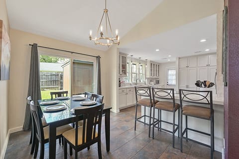 Seamless flow from kitchen to dining room enhances sociable dining experiences.