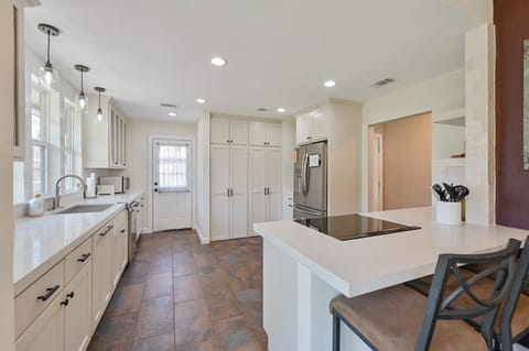 Abundant natural light bathes the kitchen, creating a warm, inviting ambiance.