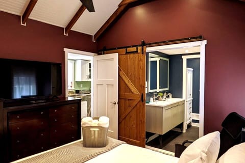 Master Bedroom & en suite bathroom with sliding barn privacy door, dual vanity, jet tub and private toilet with sliding glass privacy door