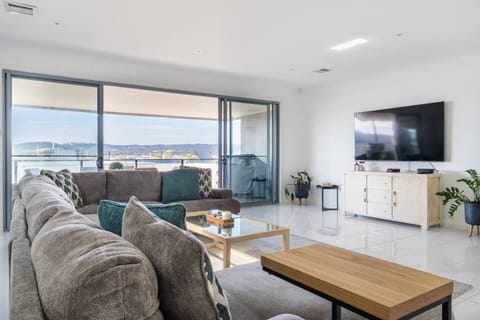 A TV in the living area caters to your evening entertainment, while large sliding doors extend to the undercover patio.