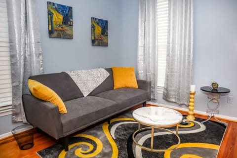Relax in bedroom's 2 casual charm, with a plush couch, center table, and carpet.