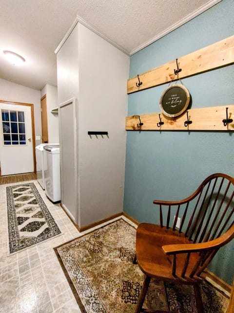 Mud Room off from side entrance with washer and dryer. 