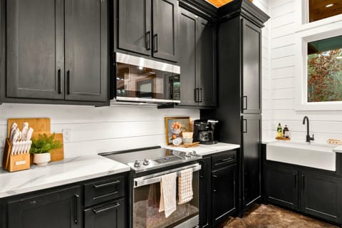 Sleek black cabinetry that offers ample storage and a striking contrast against the white countertops.