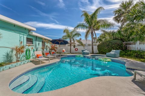 Relax in the fully fenced backyard with a private heated pool and spillover spa.