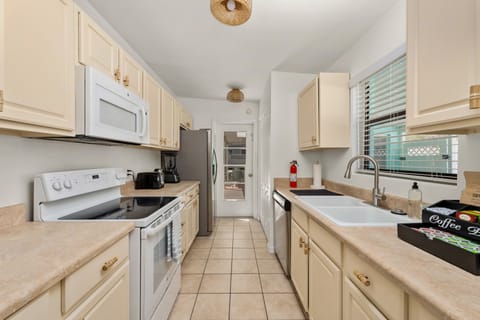 Seamless transition: Kitchen opens up to pool area for easy access to drinks and snacks.