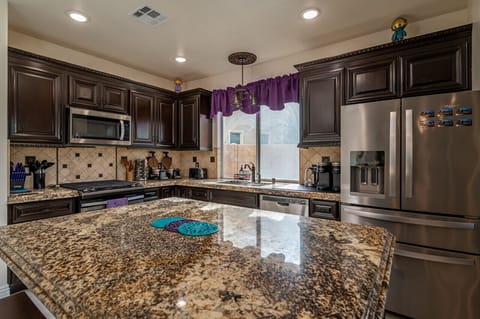Kitchen is loaded with appliances and supplies