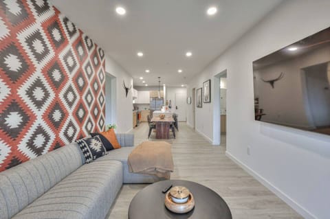 WiFi, Smart TV, extra blankets, open kitchen layout, sliding glass doors to deck with city views, AC/heating, smoke alarm, fire extinguisher, and sound system.