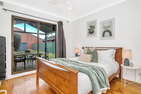 The second bedroom includes a queen bed and direct access to the backyard, while both bedrooms offer ceiling fans. 
