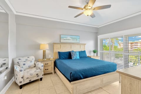 The master bedroom features a plush king-size bed, walk-in closet, ensuite bathroom, Smart TV, and balcony access.
