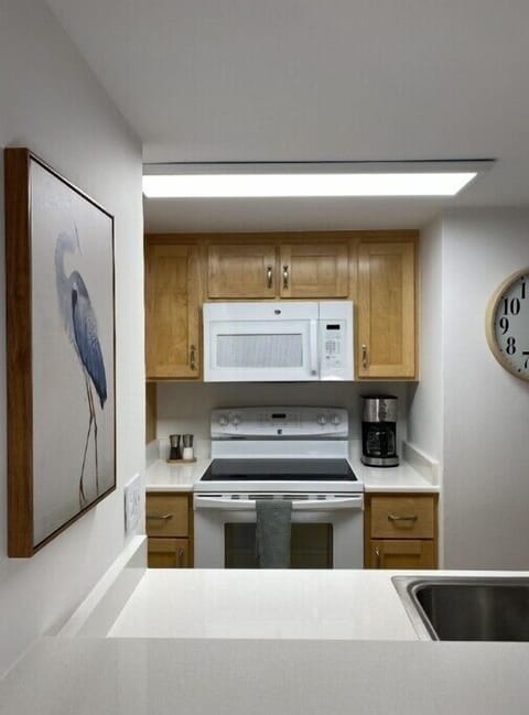 Microwave, stove, oven, and coffee maker.