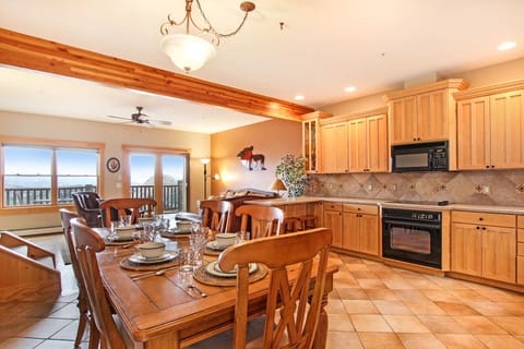 At the top of the stairs you'll find an open concept main level with kitchen, dining table with seating for six, and living room. 