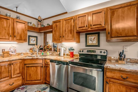 Plenty of space for meal prepping, Kitchen features an Electric glass top stove/oven and a dishwasher.
