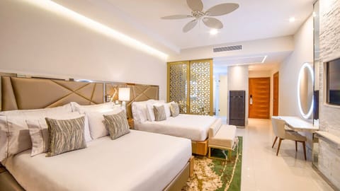 Luxury room at Garza Blanca Cabo with two queen beds, modern decor, & amenities.