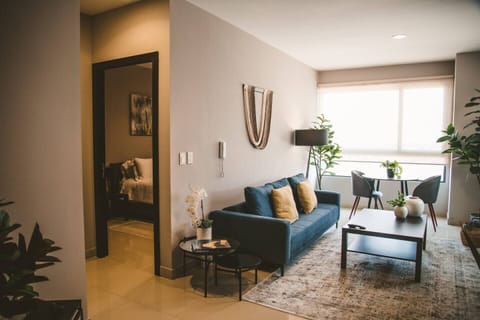 A versatile and cozy nook in the apartment, perfect for unwinding with a TV, enjoying meals at the table, working, or settling down with a good book