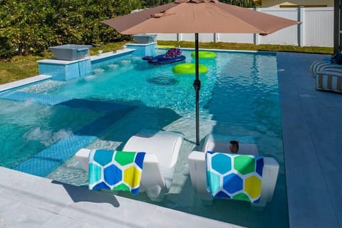 Unwind in style: A designer pool at your vacation home, where luxury meets leisure in a haven of relaxation and sophistication.