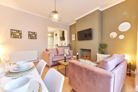 Make yourself at home in our living room haven, where chairs beckon, natural light dances, and beautiful pictures adorn the walls