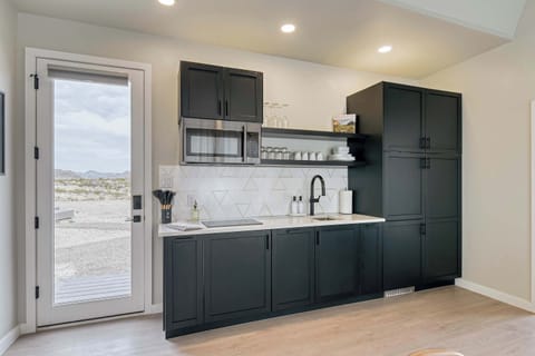 Full kitchen, including full-size fridge (inside the cabinet), freezer, dishwasher, microwave, stove and more
