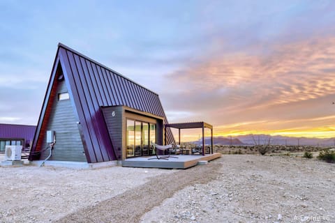 Exterior view of A-Frame #6  with a gorgeous sunrise behind the Chisos Mountains