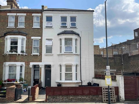 Exterior of the home - A beautifully maintained three-story end-of-terrace home with a fresh white facade, offering a perfect blend of character and modern comfort