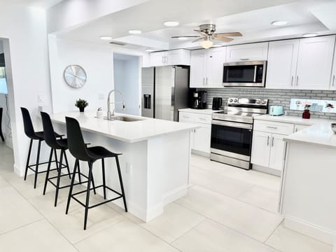 This fully updated kitchen offers sleek finishes, ample counter space, and an oversized island that serves as both a prep area and casual dining spot.