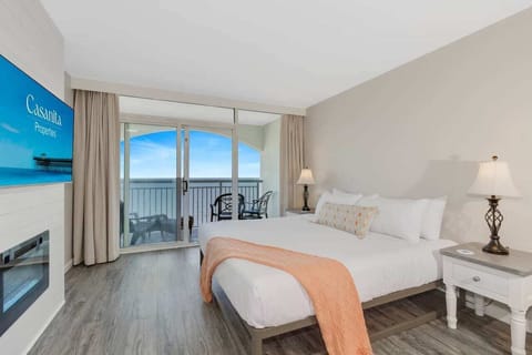 Wake up to stunning oceanfront views in this serene, stylish bedroom featuring a plush bed, cozy ambiance, and private balcony access. Perfect for a relaxing getaway, unwind with the sound of the waves and modern comforts.