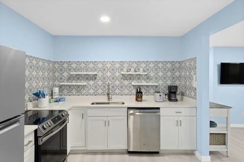 Fully stocked kitchen with brand new appliances and cute dining table overlooking front driveway