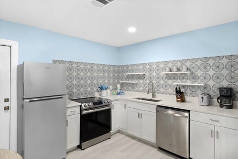 Fully stocked kitchen with brand new appliances and cute dining table overlooking front driveway
