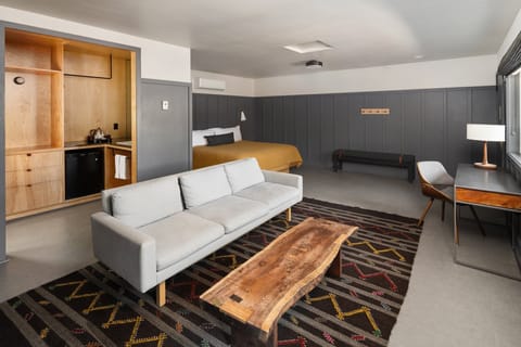 Unwind in a stylish open-plan suite with cozy zones.