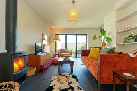 The open plan living area has two trifold windows which open out onto a huge patio