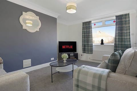 Spacious living room equipped with a SMART TV with Netflix and plenty  of space to sit down and relax. 