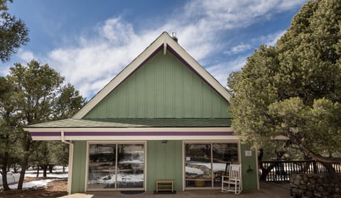 House exterior amid pinyon pine forest