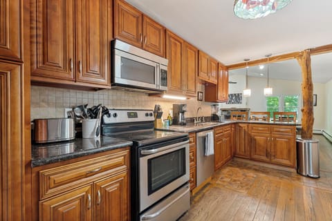 The spacious, fully equipped kitchen is ready for your cooking creativity. Make those tasty meals and serve them on the adjacent dining table.