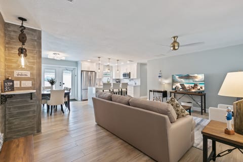 Living Room looking to the Kitchen with a charging station on the left. 
