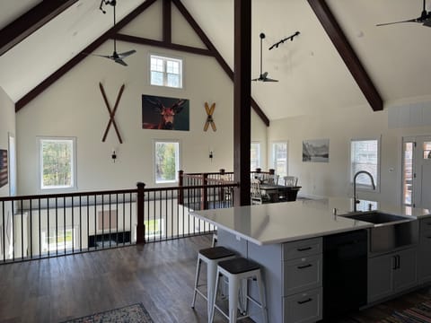 View of main level next to deck doors, upstairs sitting room directly behind