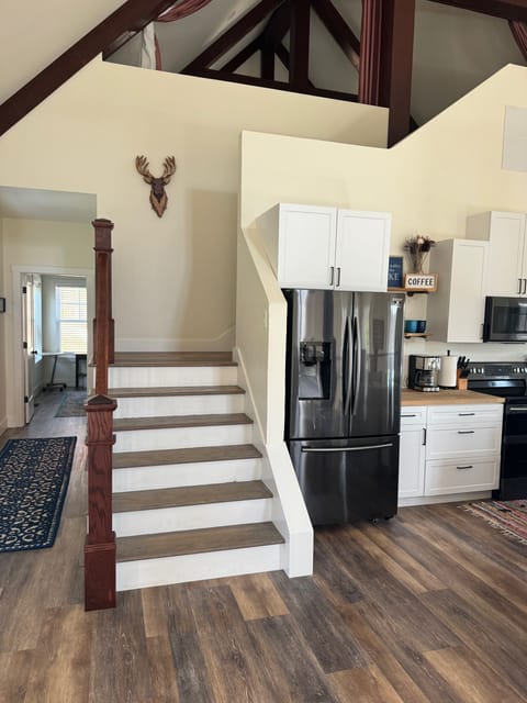 Hallway leading to main level bedroom & bathroom on the left